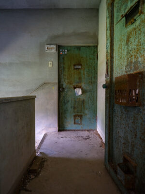 Decaying interior contrasted by vibrant green door