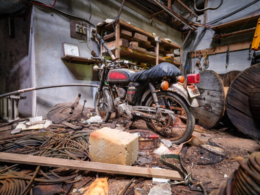 Vintage motorcycle garage clutter workshop.