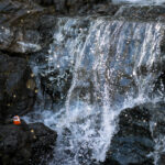 Majestic waterfall cascading rocky cliffs.