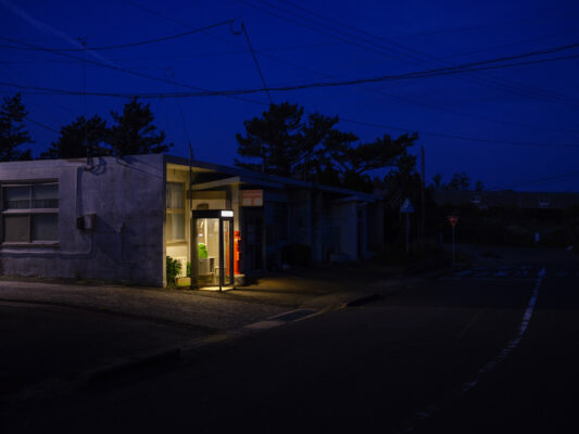 Cozy illuminated cottage red door night scene