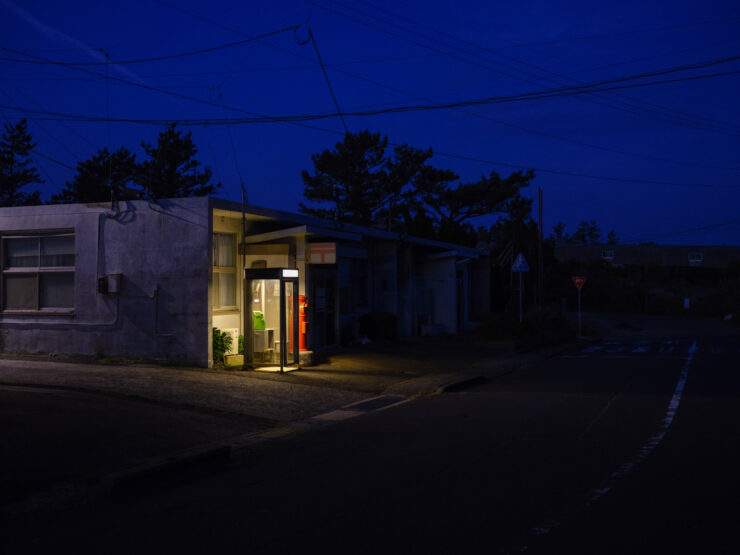 Cozy illuminated cottage red door night scene