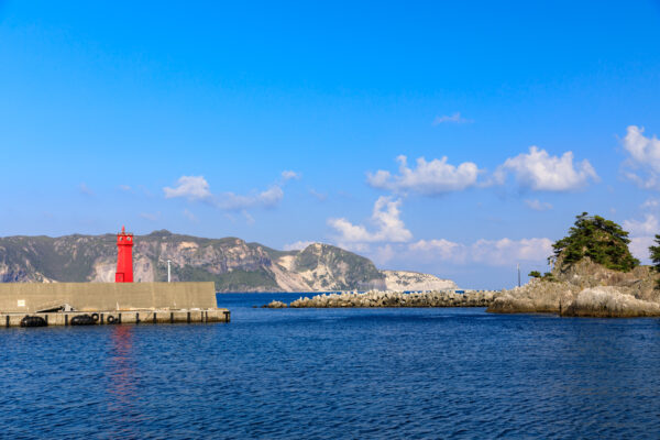 Vibrant lighthouse on tranquil Shikinejima Island, Japan