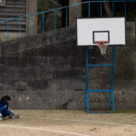 Quiet solitude on community basketball court.