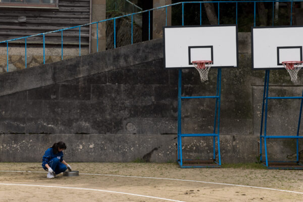 Quiet solitude on community basketball court.