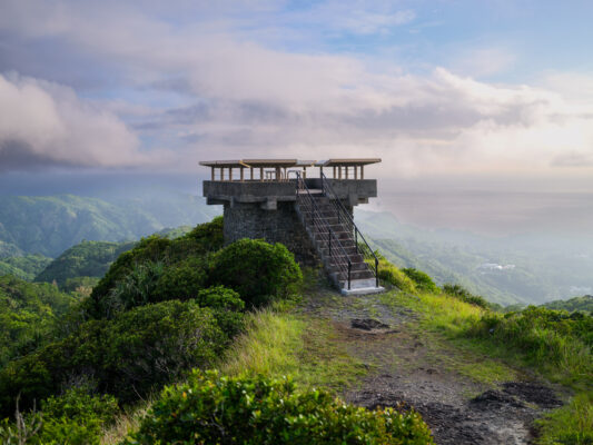 Panoramic hilltop observation deck overlooking lush landscape