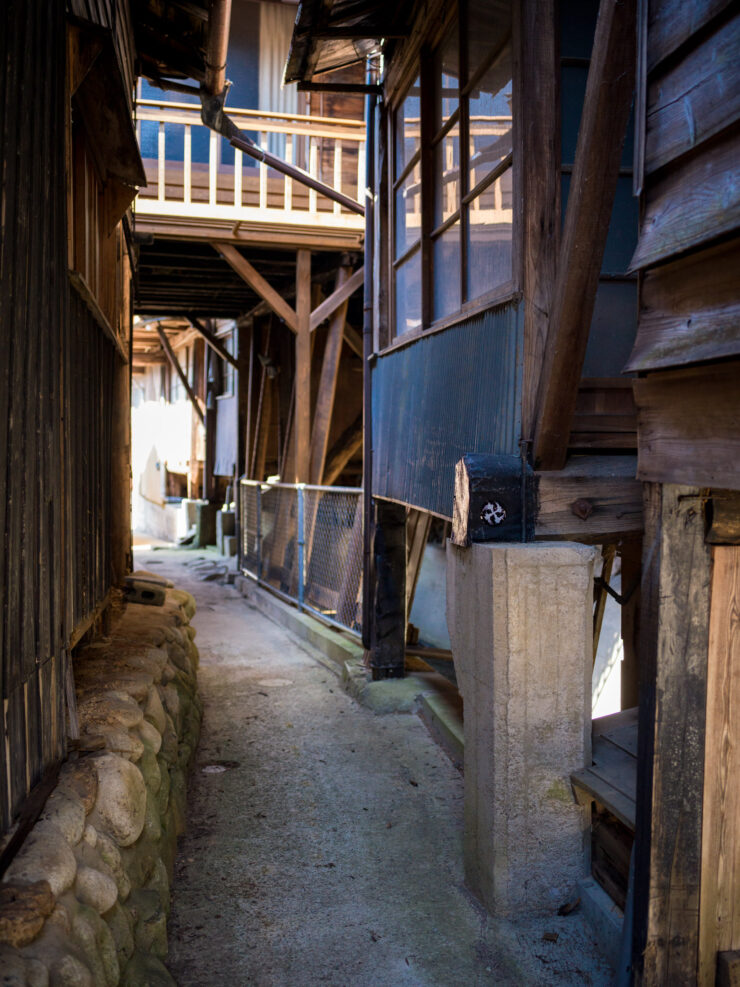 Traditional Japanese alleyway golden light nostalgia.