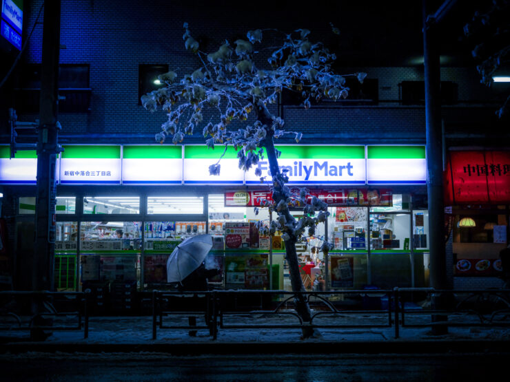 FamilyMart convenience store glowing on snowy night.