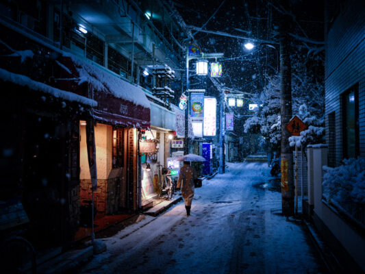 Snowy historical village street at night