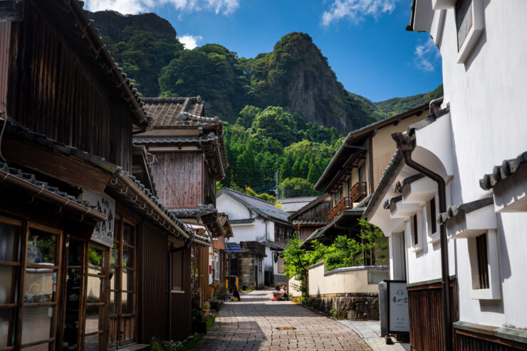 Picturesque Japanese village street, wooden buildings, mountains