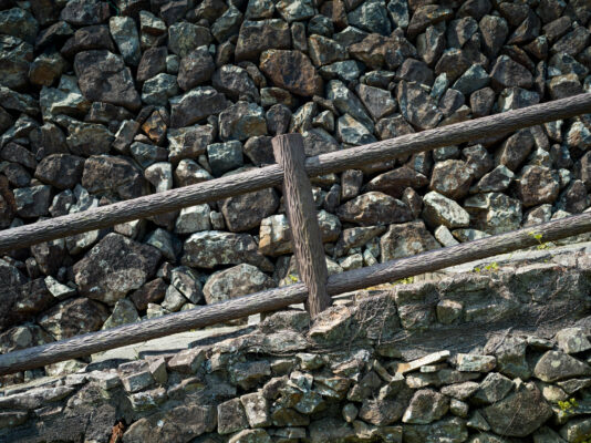 Weathered Rustic Fence Amidst Rocky Landscape