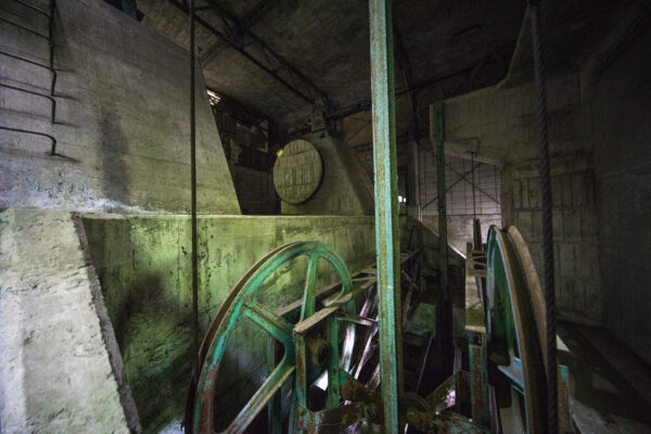 Haunting abandoned factory remnants, rusted machinery.