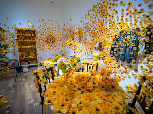 Yayoi Kusamas captivating sunflower installation immerses visitors.