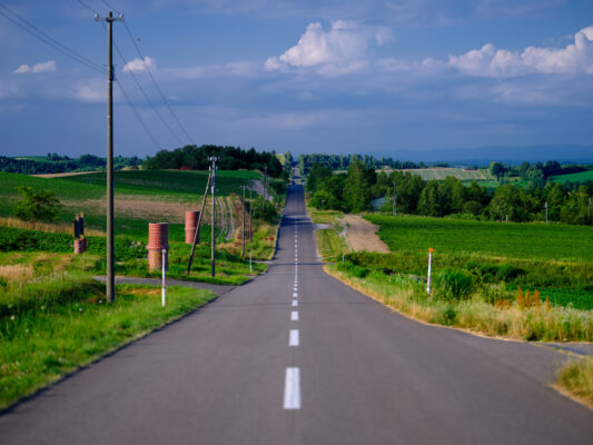 Picturesque country lane winding through verdant hills