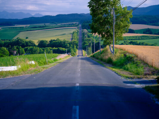 Scenic winding countryside road through verdant hills