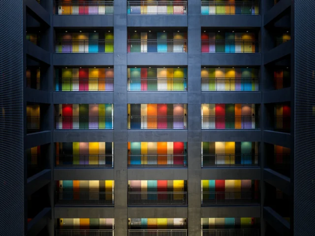 Rainbow balconies, Colors dance on gray canvas— Urban art alive.---レインボー・バルコニー、 灰色のキャンバスに踊る色— 都市のアート生きる。---#rainbowfacade #urbanart #colorfularchitecture #japanesearchitecture #modernjapan #offbeatjapan #japan