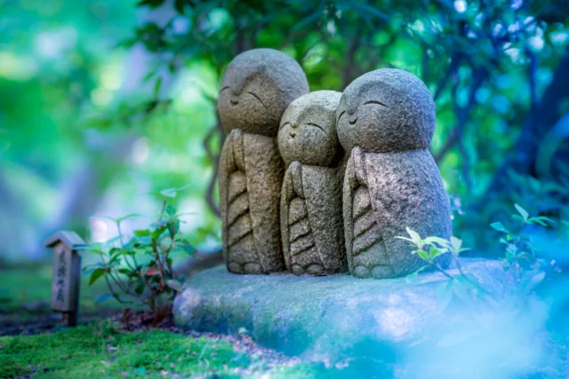 Stone Jizo embrace, Green whispers in gentle hues, Peaceful light cascades. ---石の地蔵 抱き合い緑の 囁き 優しい光 ---#jizostatues #serenebeauty #greenpeace #templevibes #offbeatjapan #japan #tranquilityvibes