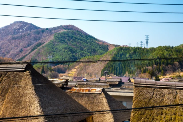Thatched roofs whisper tales, Green hills cradle time's embrace— Wires sketch future dreams. 茅葺屋根 物語を語る 緑の丘に抱かれて— 未来を描く糸。 #offbeatjapan #japan #traditionandmodernity #ruraljapan #thatchedroofs #natureandtechnology #historicalarchitecture